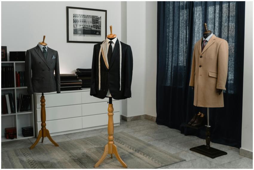 Stylish men's suits on mannequins in an atelier, s