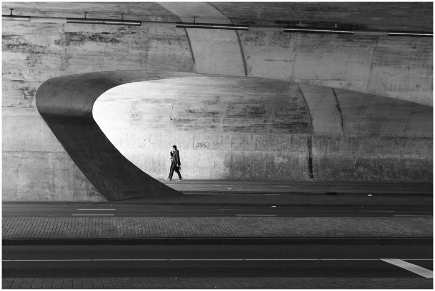 A person walks alone in a modern architectural tun