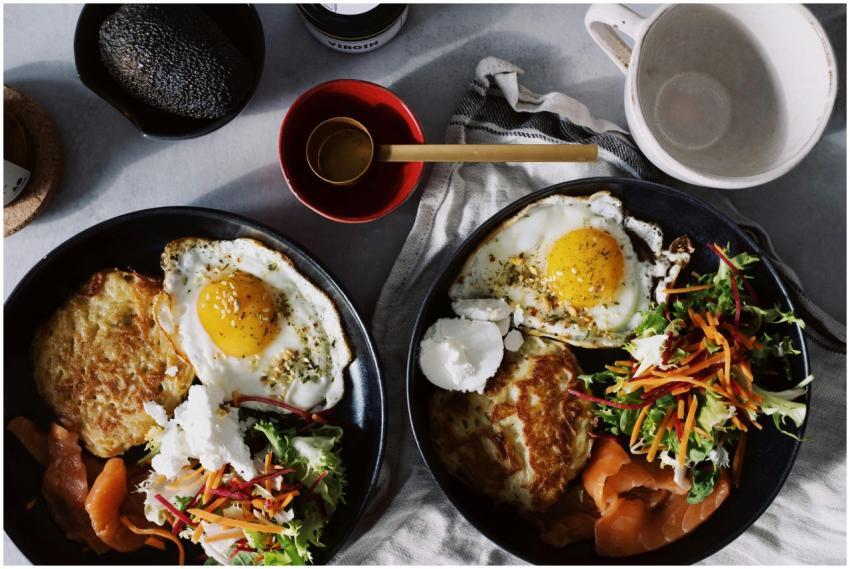 A vibrant brunch spread featuring eggs, smoked sal