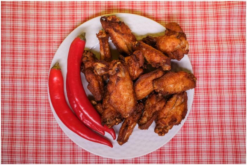 Top view of plate with tasty fried chicken wings w