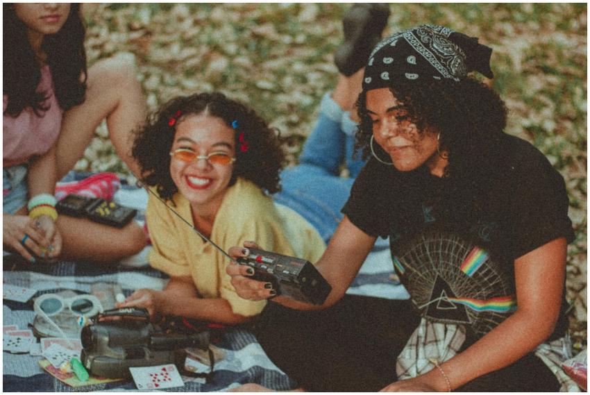 Three women having fun with a vintage radio at an
