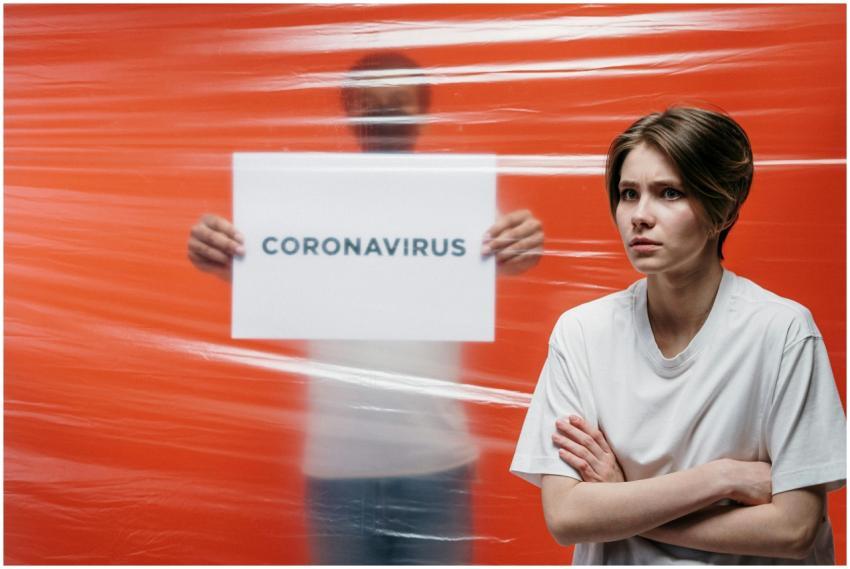 A worried person standing in front of a transparen