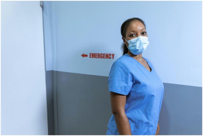 Nurse wearing mask in hospital emergency corridor