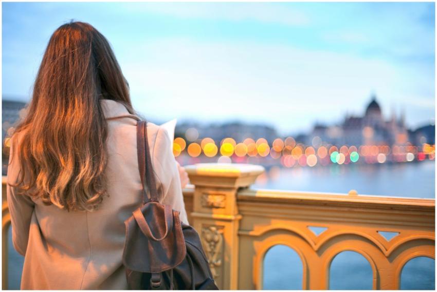 A woman enjoys a scenic view of Budapest's Danube