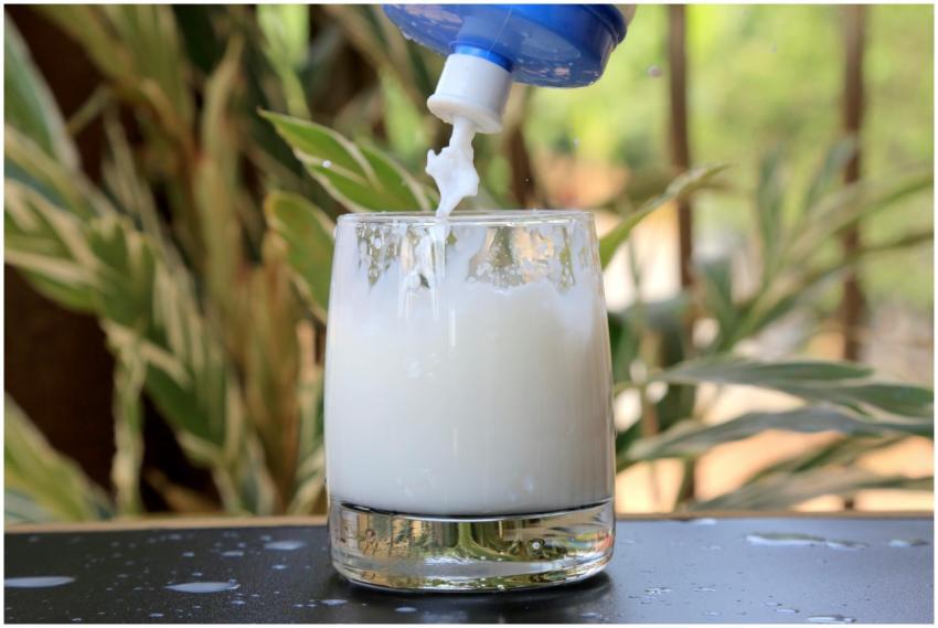 A refreshing white liquid pouring into a glass out