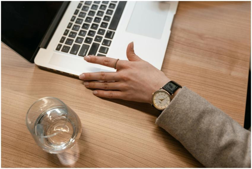A close-up of a woman's watch-adorned hand on a wo