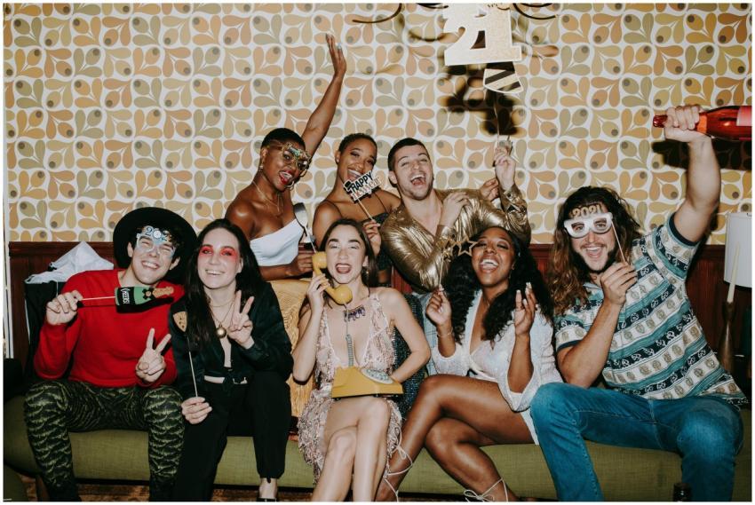 Joyful friends celebrating New Year's Eve at a fes