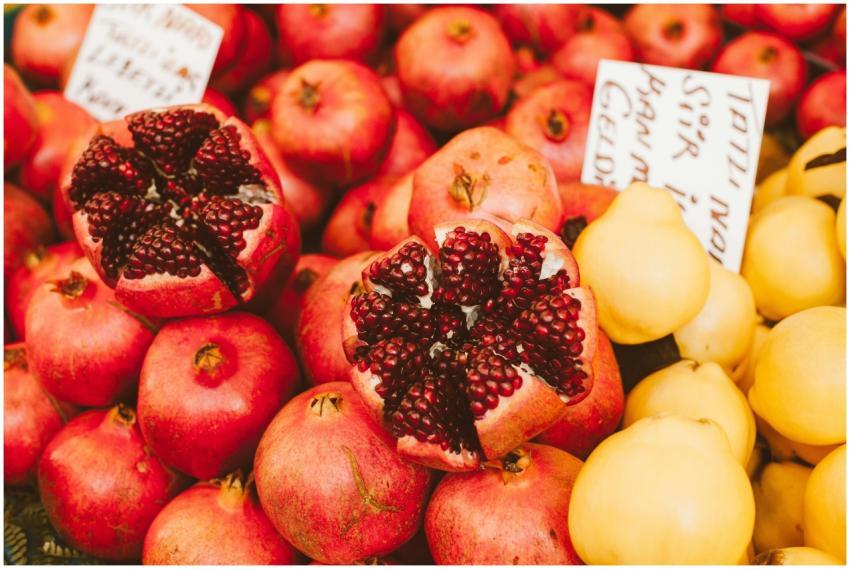 Fresh and colorful market display featuring pomegr