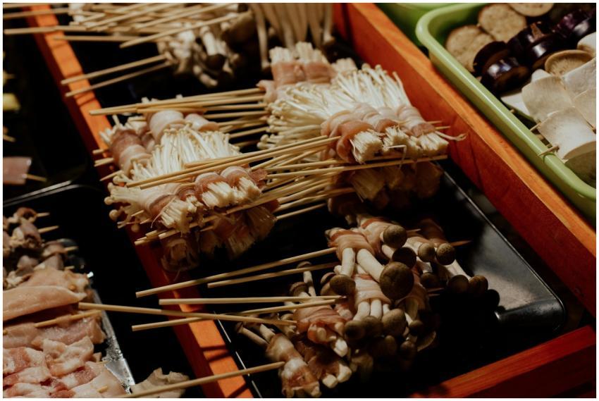 A vibrant display of skewered mushrooms wrapped in