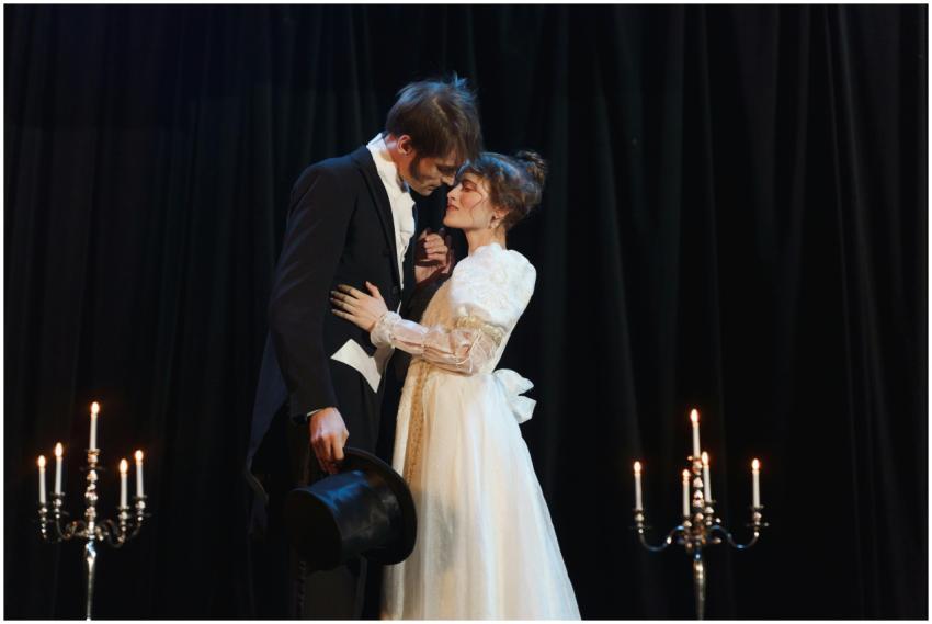 A dramatic romantic scene on stage with a couple i