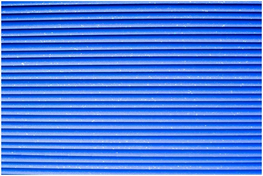 Close-up of a vibrant blue corrugated metal textur