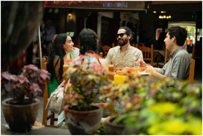 Friends enjoying a meal and conversation in a live