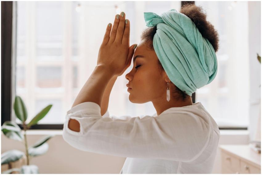 Woman practicing meditation indoors with a focus o