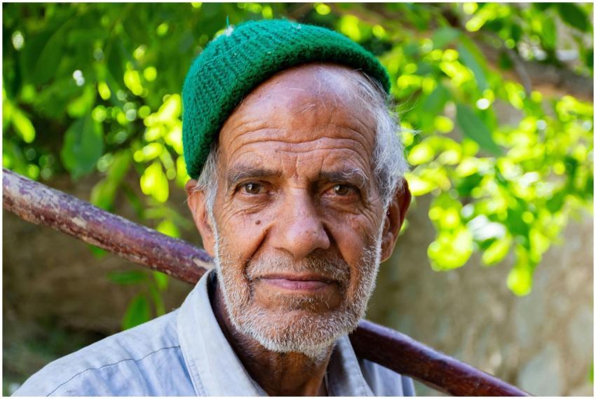 Close-up portrait of an elderly farmer with a warm
