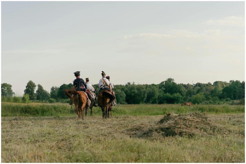 Group of cavalrymen in period costume riding throu