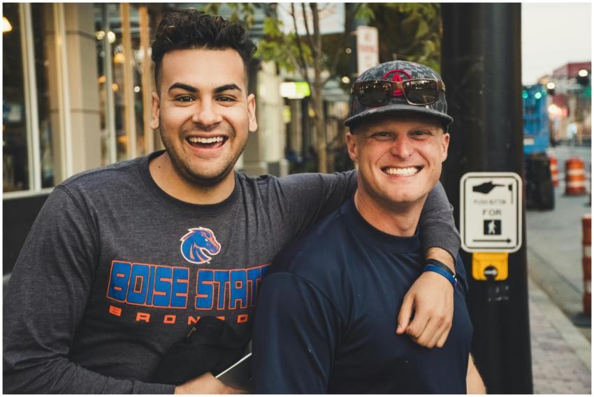 Two men enjoying a sunny day in the city, smiling