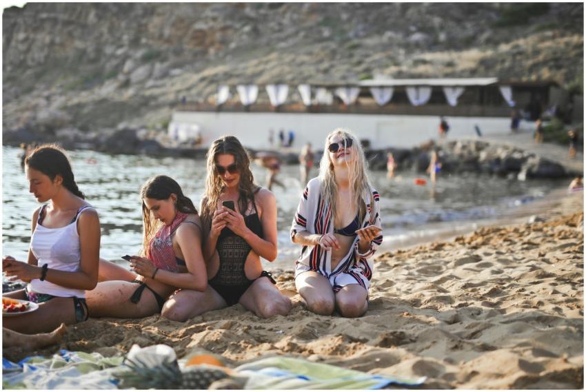 A group of friends enjoying the sun and sea at a b