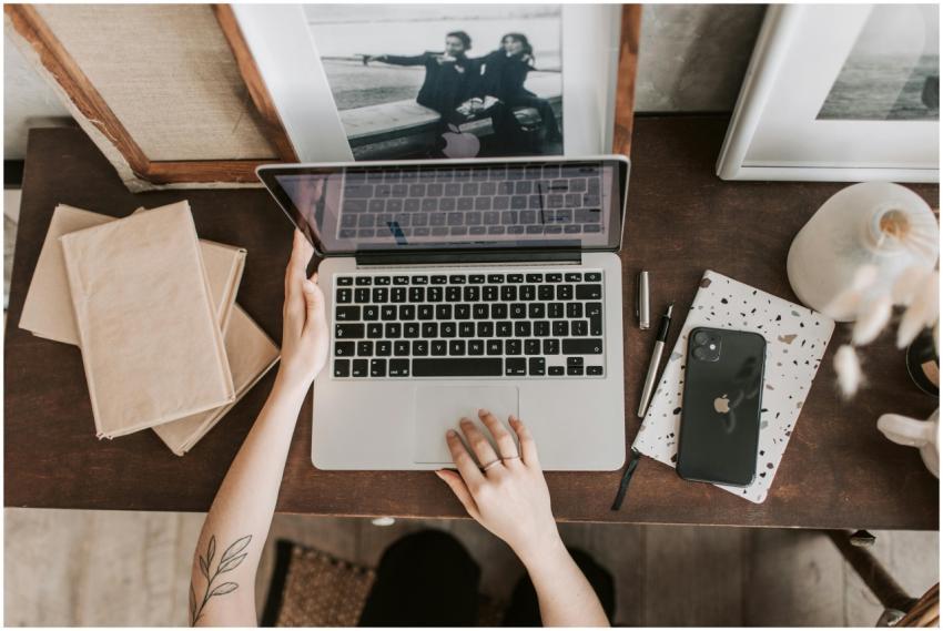 An aesthetic workspace featuring a laptop, smartph