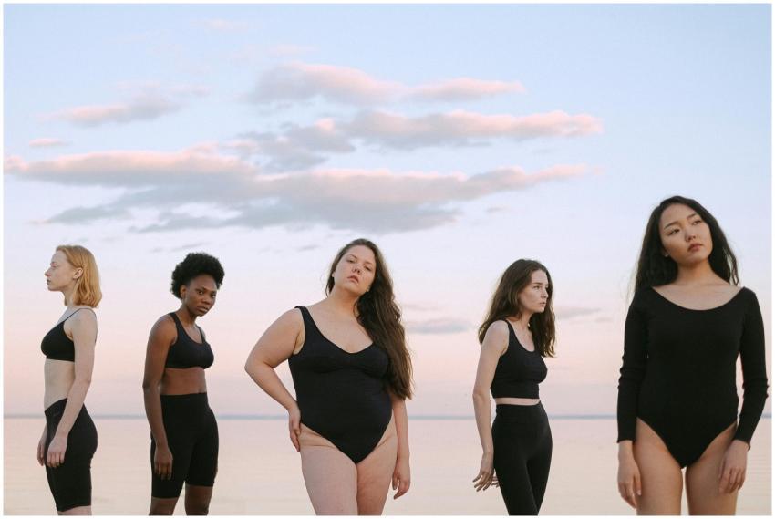 Five diverse women in swimwear posing confidently