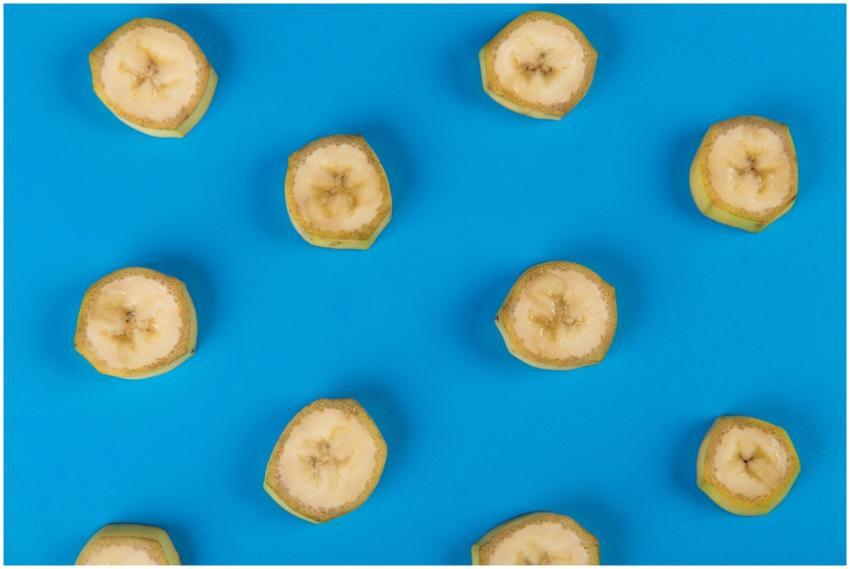 A top-down view of sliced bananas arranged on a vi