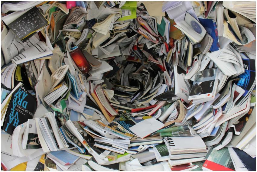 A whirlwind of books and papers creating a chaotic