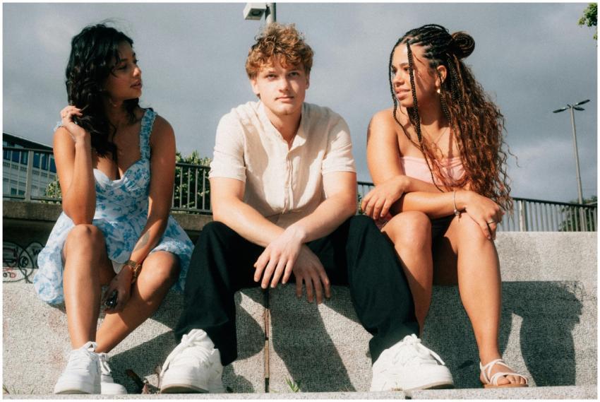 A diverse group of friends sitting on steps outdoo