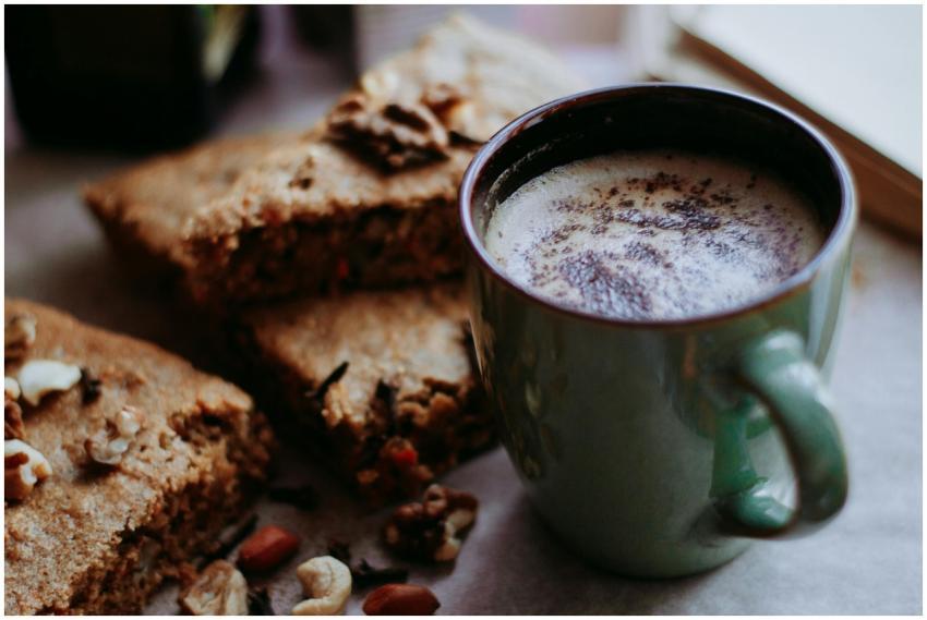 Delicious warm coffee served with slices of nutty