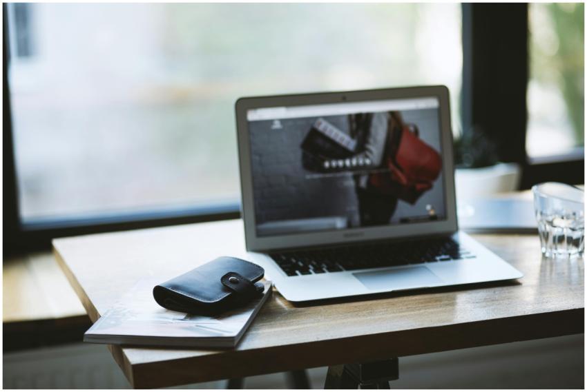 A contemporary workspace featuring a laptop and wa