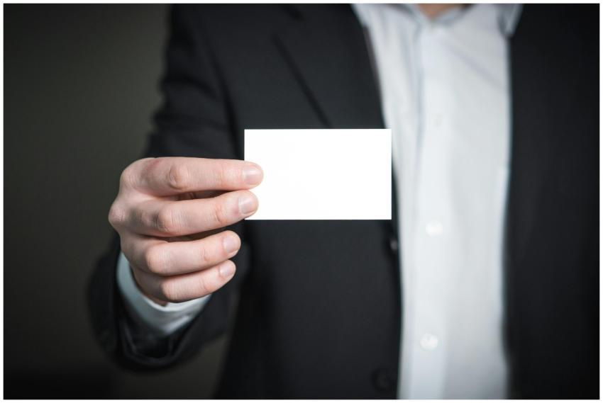 Professional holding a blank business card, ideal