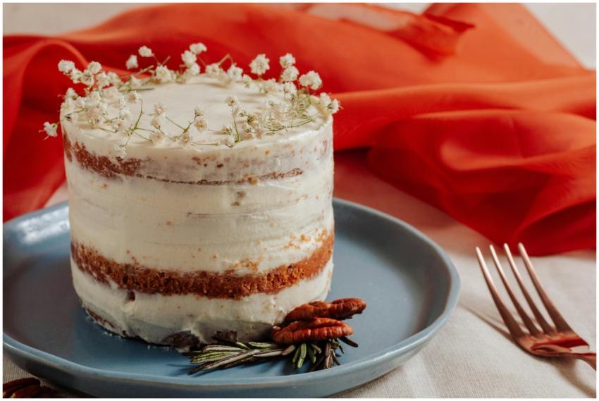 A beautifully decorated naked cake with floral acc