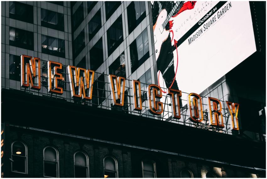 Low angle view of New Victory signage on city buil