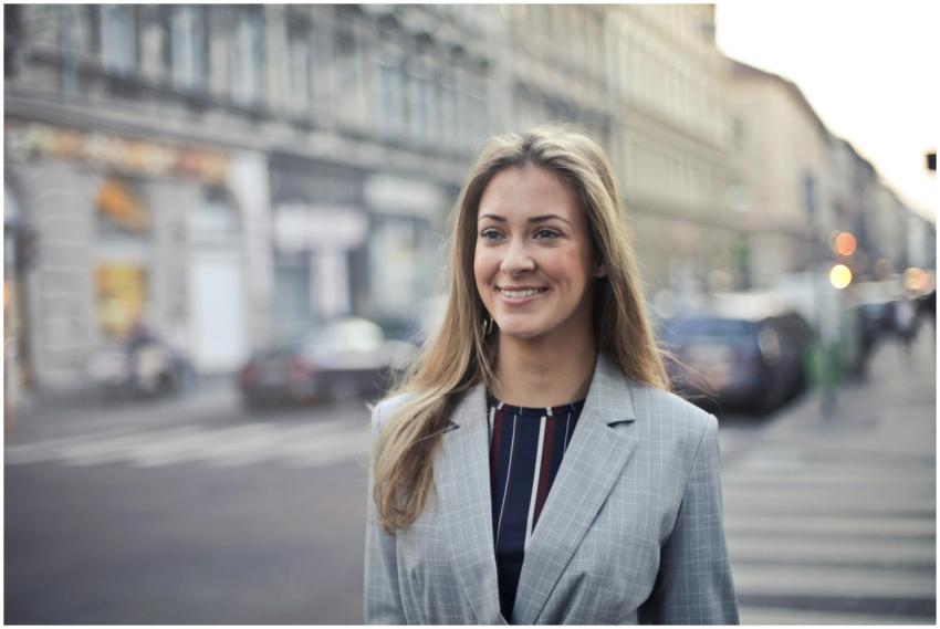 Confident businesswoman smiling outdoors in urban