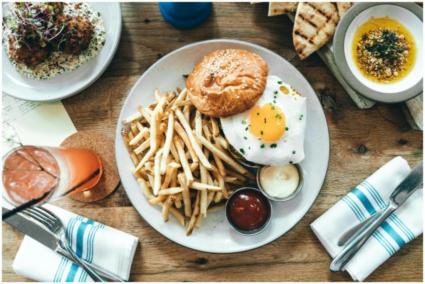 A delicious gourmet burger with fries and a fried