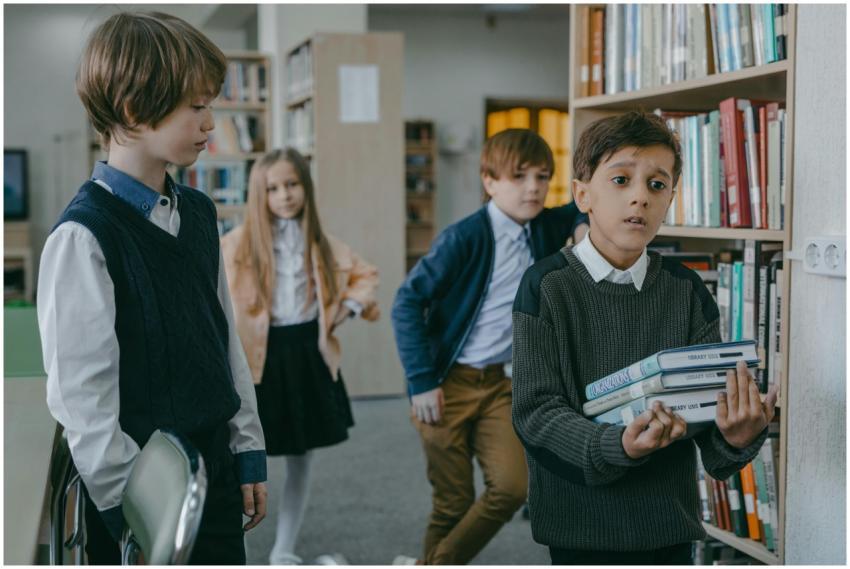 A group of children interacting in a library setti