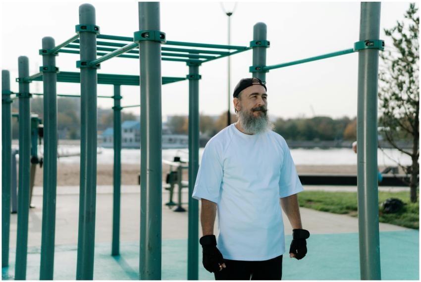 Senior man exercising on outdoor fitness equipment
