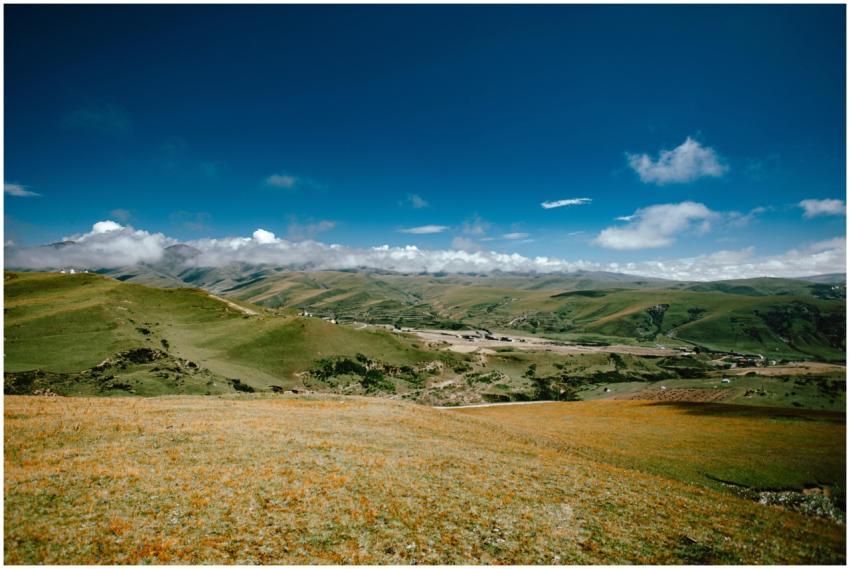Sprawling green mountains with a clear blue sky an