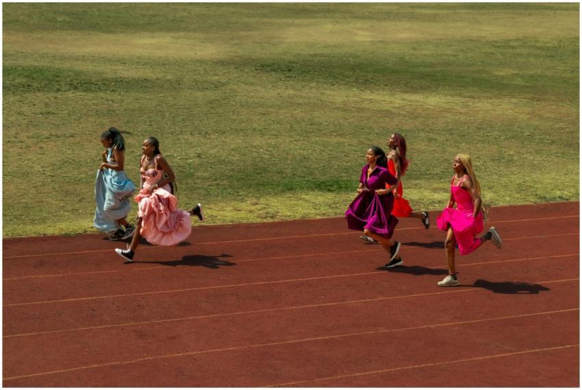 A unique scene of women in vibrant dresses sprinti