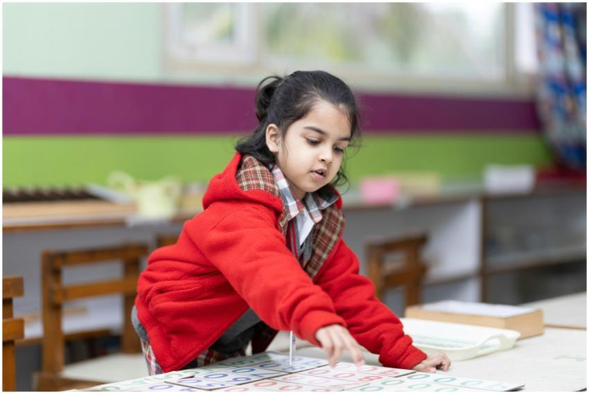 A young girl engages with educational materials in