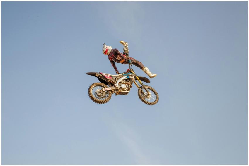 Thrilling motocross rider performing a daring stun