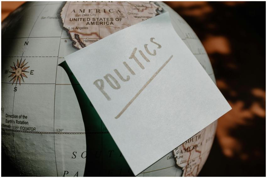 A close-up of a globe with a politics sticky note,