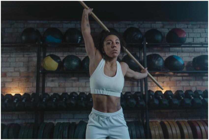 Athletic woman practicing fitness moves using a wo