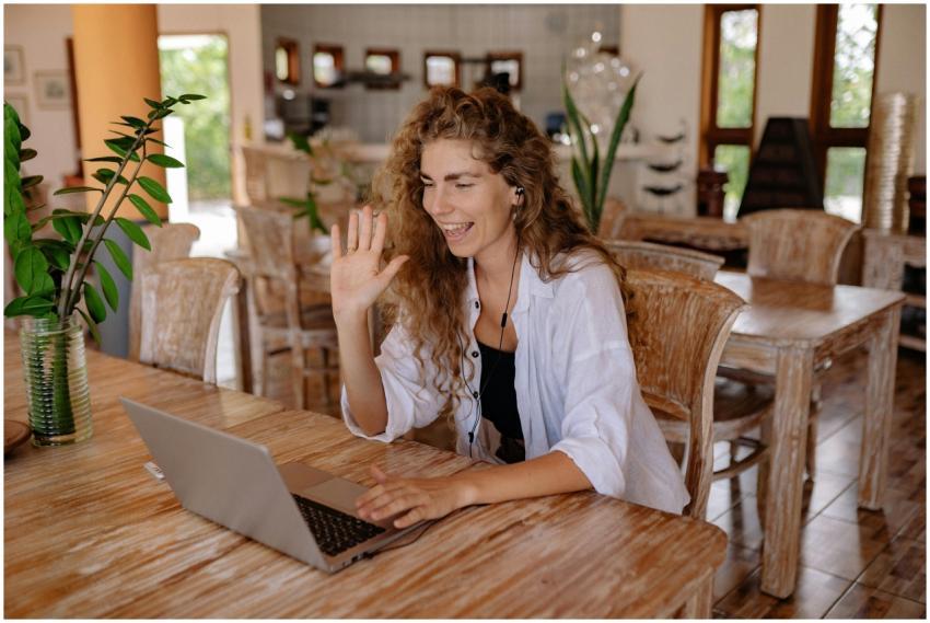 Smiling woman having a video call in a home-like s