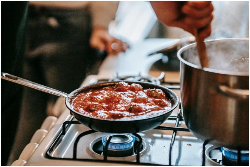 Crop unrecognizable person stirring boiling water