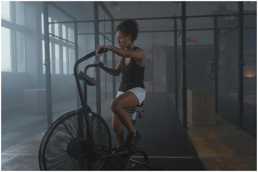 African American woman exercising on an air bike i