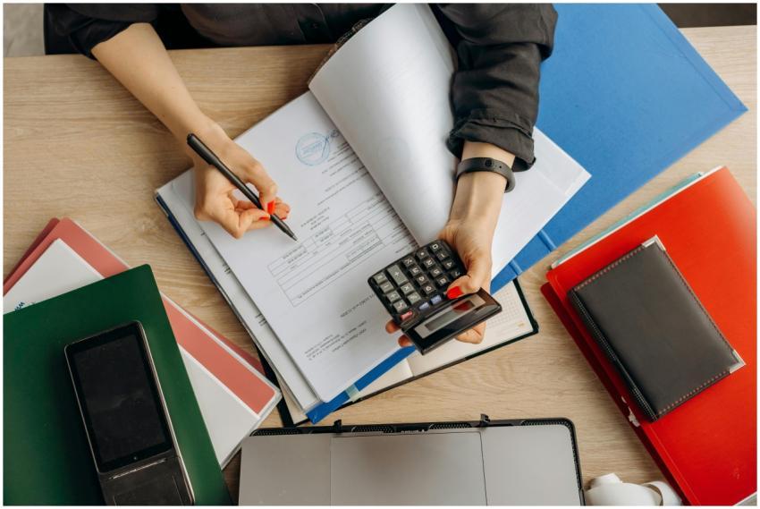 Accountant analyzing financial documents with a ca