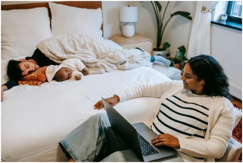 High angle of joyful young ethnic mother smiling w