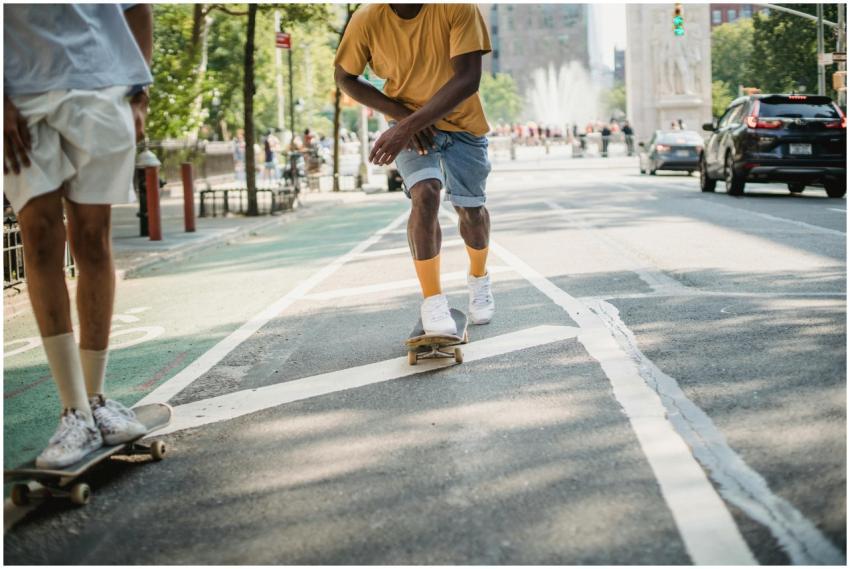 Crop anonymous multiracial male skaters in casual
