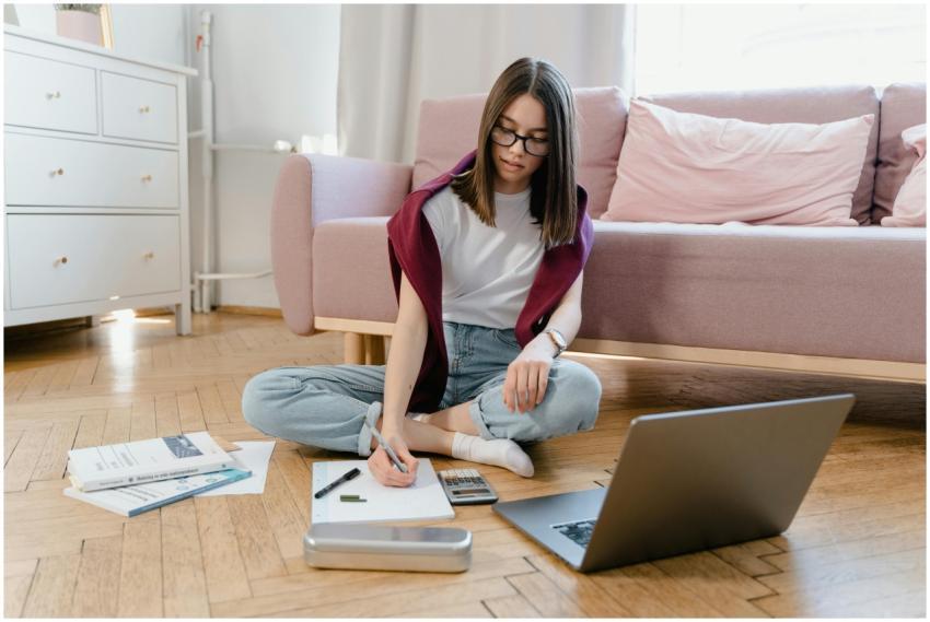 Teen girl studying in a cozy living room setting,