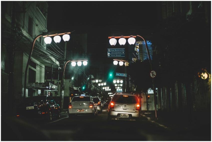 City street at night with cars and illuminated str