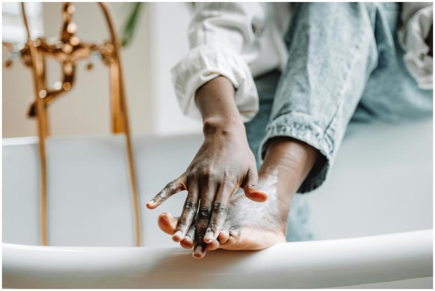 Focused view of a person applying foot cream while